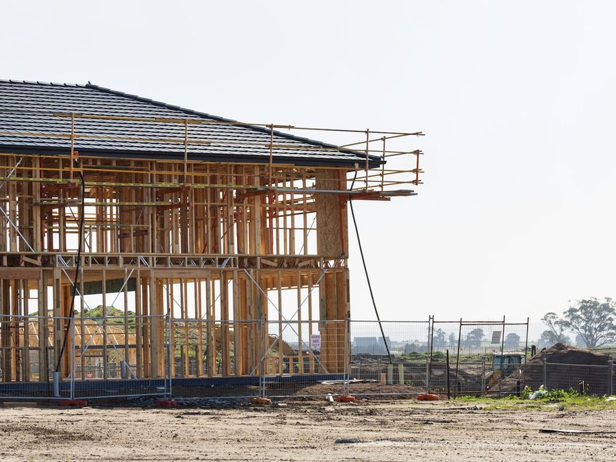 A two-story home framed out on a construction site. Construction and extraction jobs make up 9.9 percent of employment in the Greeley metro, more than twice the national share.