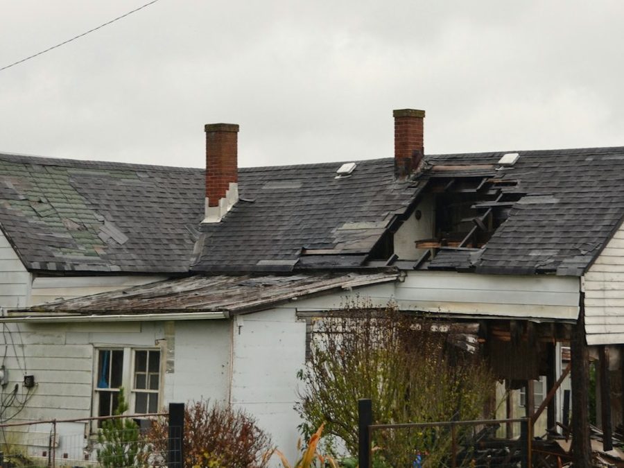 A weathered house with a damaged roof. Hail accounts for roughly half of a Front Range homeowners premium, according to the Division of Insurance.